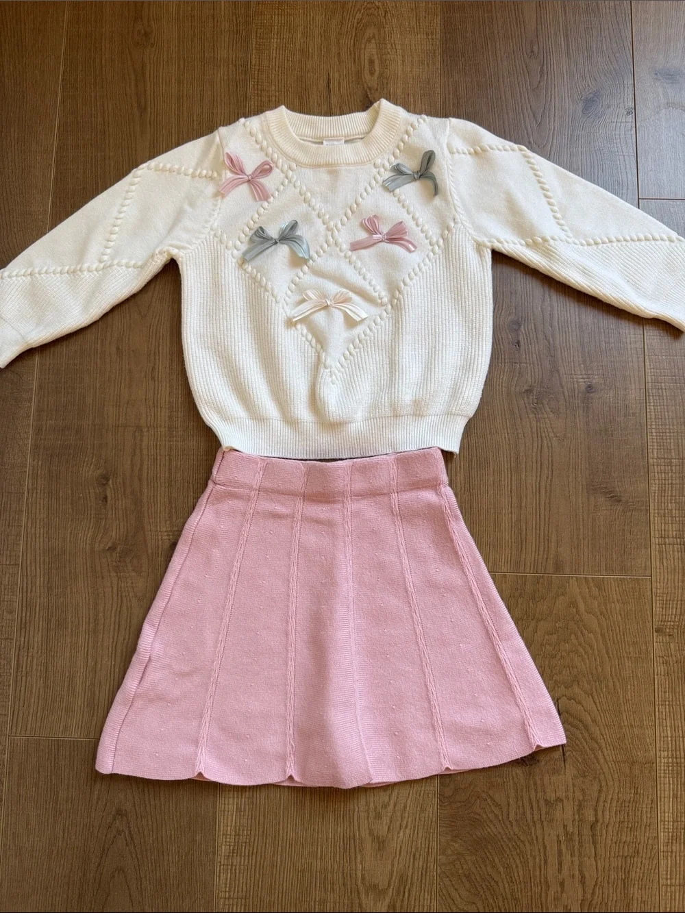 Cream Bow-Appliqué Knit Sweater with Pink Accent and Matching Pink Skirt